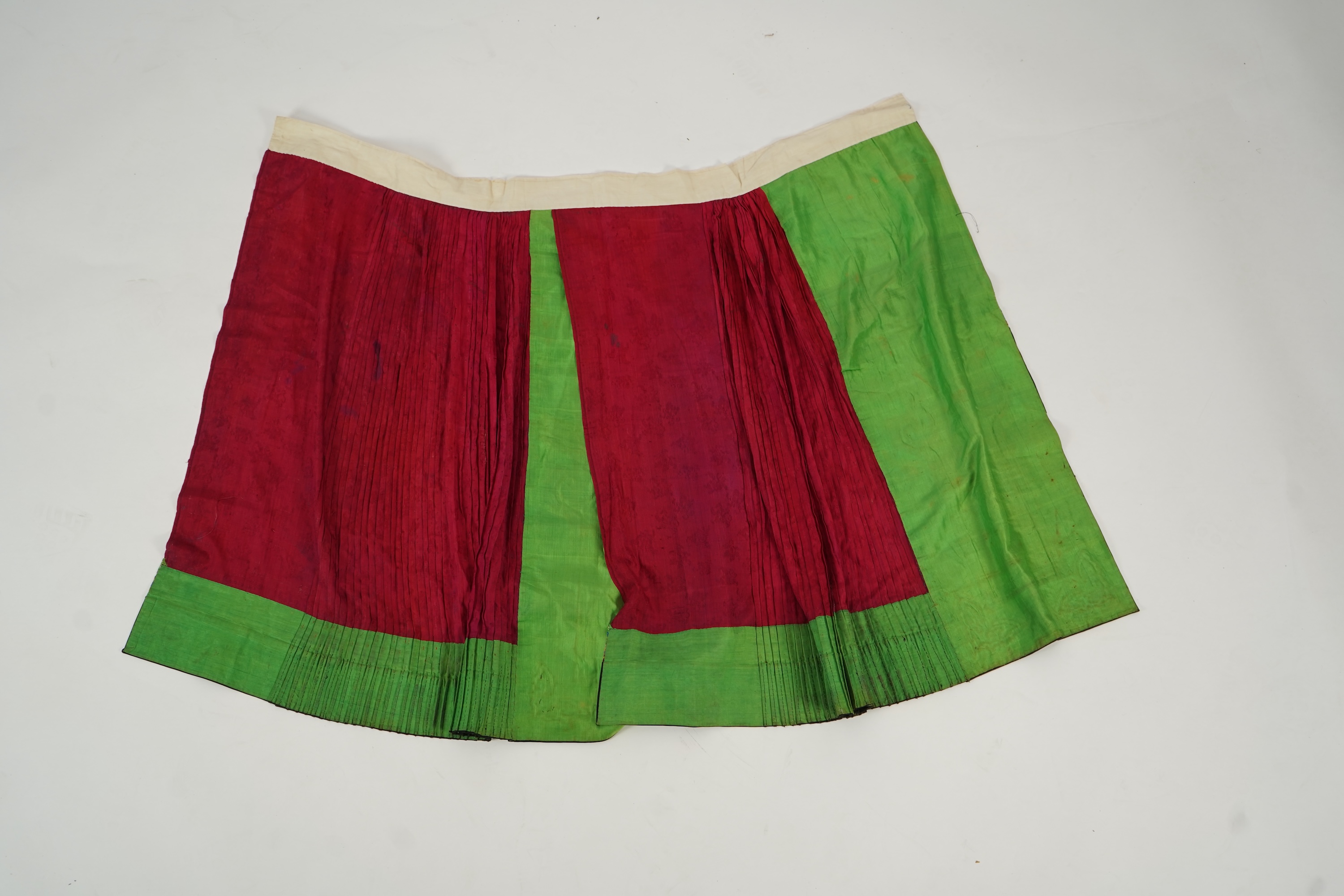Two Chinese embroidered silk wedding skirts, late Qing, five hats, trousers, two skirt panels and two others, collar and a panel